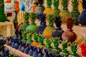 Three shelves of ceramic pineapple shaped containers.