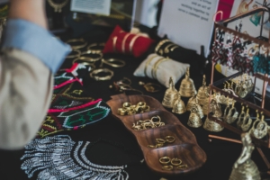 A table full of homemade jewelry.