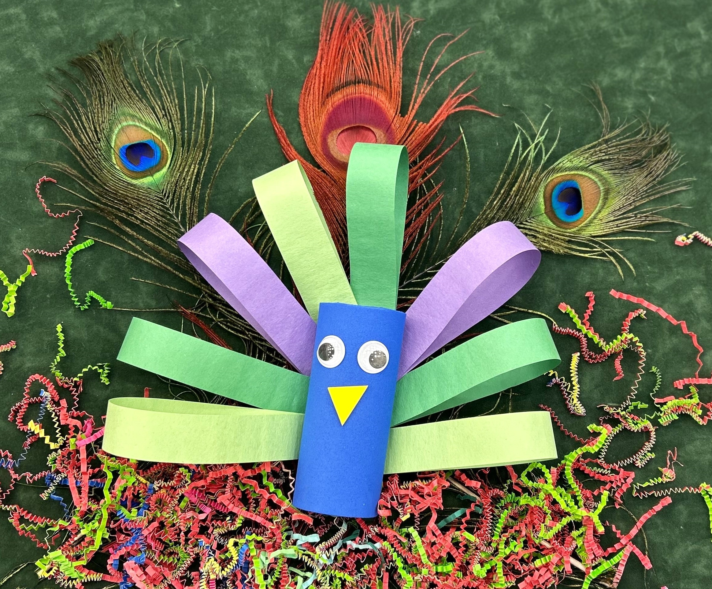 A peacock made from colorful pieces of paper.